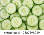 Cucumber background. Round cucumber slices, top view.