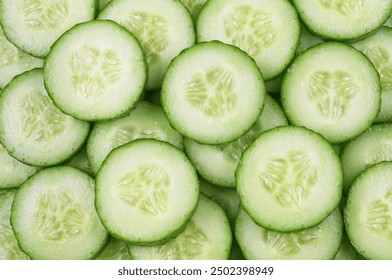 Cucumber background. Round cucumber slices, top view.