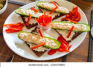 Cucumber Cut In Half With Fresh Quark And Pepper Strips Stuffed On Black Bread. A Low-calorie Meal And Vegan Entree