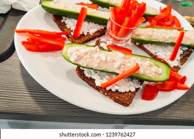 Cucumber Cut In Half With Fresh Quark And Pepper Strips Stuffed On Black Bread. A Low-calorie Meal And Vegan Entree