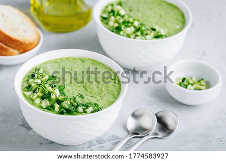 Cucumber Gazpacho. Green fresh cold summer soup on gray stone background