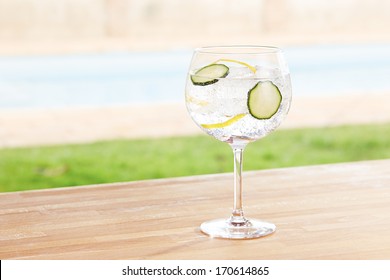 Cucumber Gin And Tonic Cocktail On Poolside Bar