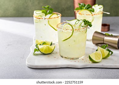 Cucumber margarita with lime and spicy rim, refreshing spring cocktail with copy space - Shutterstock ID 2252751159