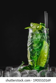 cucumber and mint lemonade in a glass on black wooden table background