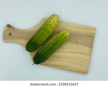 Cucumber on a wooden cookware - Shutterstock ID 2338313657