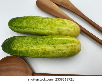 Cucumber on a wooden cookware - Shutterstock ID 2338313721