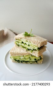 Cucumber Sandwich Made With Whole Wheat Bread, Cream Cheese And Coriander Chutney. Finger Sandwiches On A White Plate For English Afternoon Tea. Square Sandwich Cut In Half. Vertical Image.