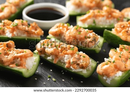 Cucumber Shrimp Sushi Boats with Spicy Mayo, Rice, Chives and sesame seeds