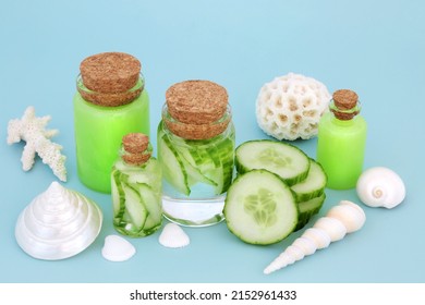 Cucumber Skin And Body Care Treatment With Natural Hydrating Products  In Glass Bottles. Used Also As After Sun Care To Cool Sunburn And Bathe Tired Eyes. On Pastel Blue Background.