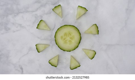 Cucumber Slices Arranged Decoratively On A Marble Kitchen Worktop