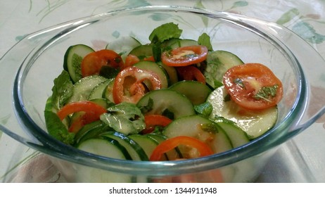 Cucumber and tomato salad with mint leaves in olive oil and lemon vinaigrette