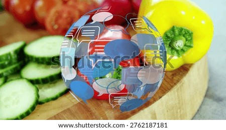 Cucumbers stacking, causing chat sphere overlaying tomatoes and bell pepper, illustrating food prep. Kitchen, vegetables, cuttingboard, countertop, closeup, vibrant, colorful