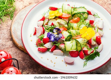 Cucumber,tomato,radish and greens salad decorated with edible flowers.Spring colourful salad - Shutterstock ID 1961009632