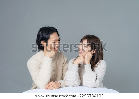 Cuddling Asian casual couple. Commemorative photo of the couple. Pair look.