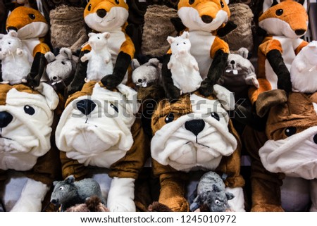 a lot of cuddly stuffed animals arranged in rows
