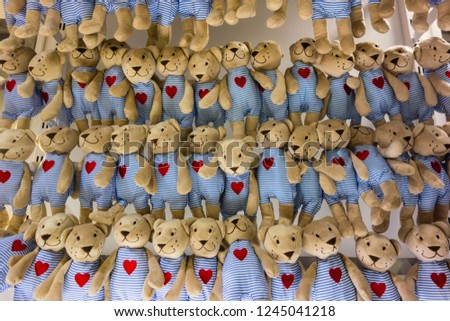 a lot of cuddly stuffed animals arranged in rows