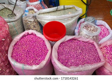 Cuenca, Azuay Province / Ecuador - December 02, 2011: Pink Color Dyed Grains For Farming And Industrial Agricultural Animal Livestock Feed Sold By Weight, The Kilogram Or Pound In A Heavy Sack