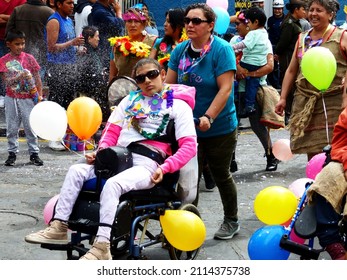 Cuenca, Ecuador - February 22, 2020: Young Man In Wheel Chair Participate In Carnival Parade In Cuenca City, Ecuador