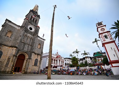 Cuetzalan Del Progreso, Puebla Mexico. May 23, 2018. Flying Dancers Performing The Dance Of The Flyers Ritual Around The 30 Meter Tree Pole Front Of The Parroquia De San Francisco De Asís. 