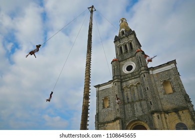 Cuetzalan Del Progreso, Puebla Mexico. May 23, 2018. Flying Dancers Performing The Dance Of The Flyers Ritual Around The 30 Meter Tree Pole Front Of The Parroquia De San Francisco De Asís. 