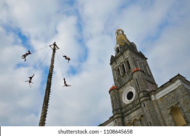 Cuetzalan Del Progreso, Puebla Mexico. May 23, 2018. Flying Dancers Performing The Dance Of The Flyers Ritual Around The 30 Meter Tree Pole Front Of The Parroquia De San Francisco De Asís. 