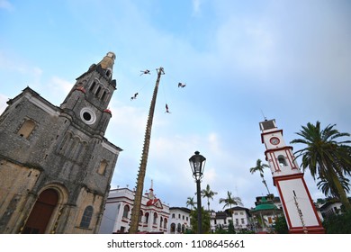 Cuetzalan Del Progreso, Puebla Mexico. May 23, 2018. Flying Dancers Performing The Dance Of The Flyers Ritual Around The 30 Meter Tree Pole Front Of The Parroquia De San Francisco De Asís. 