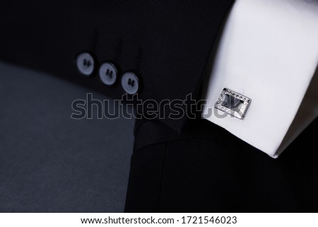 cufflink and suit on the grey background
