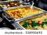 Cuisine Culinary Buffet Dinner Catering Dining Food Celebration Party Concept. Group of people in all you can eat catering buffet food indoor in luxury restaurant with meat and vegetables.