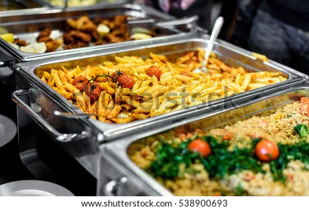 Cuisine Culinary Buffet Dinner Catering Dining Food Celebration Party Concept. Group of people in all you can eat catering buffet food indoor in luxury restaurant with meat and vegetables.
