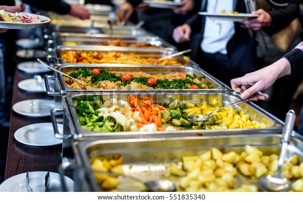 Cuisine Culinary Buffet Dinner Catering\
Dining Food Celebration Party Concept. Group of people in all you\
can eat catering buffet food indoor in luxury restaurant with meat\
and vegetables.
