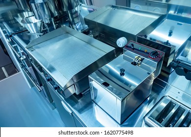 Cuisine Of The Restaurant. Concept - Restaurant Cleaning Services. Purity. Equipment For Food Production. Equipment For Restaurants. Electric Frying Pan Top View. Toaster. Deep Fryer In A Cafe.