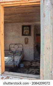 CUITIVA, BOYACA - NOVEMBER 30 OF 2020 Indoor View Of An Old Colombian Farmer House Bedroom With Old Potty, Cow Carpet And Religious Paintings