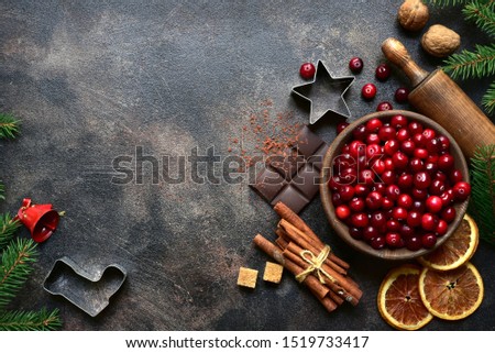 Culinary background with christmas winter spices and ingredients for baking on a dark slate, stone or concrete table. Top view with copy space.
