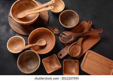 Culinary background, empty ceramic plates, wooden or bamboo spoons and bowls   . Rustic style. Home Kitchen Décor.