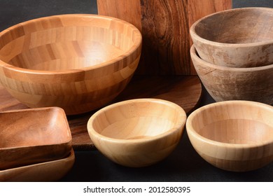 Culinary background, empty ceramic plates, wooden or bamboo spoons and bowls   . Rustic style. Home Kitchen Décor.
