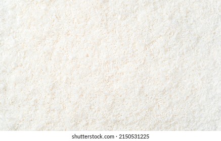 Culinary background with small, coconut chips. Top view, horizontal.