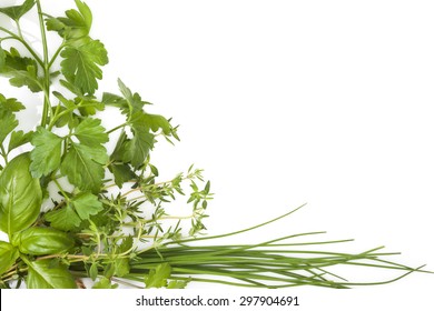 Culinary herbs background with copy space. Fresh basil, cilantro, chive, parsley and mint herbs isolated on white background, top view. Modern, minimal image style. - Powered by Shutterstock