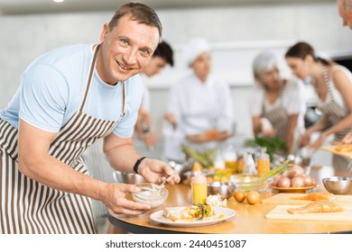 Culinary master class. The process of preparing salmon fillet with asparagus