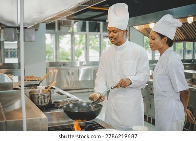 Culinary training with students practicing wok cooking skills and teamwork in professional school kitchen