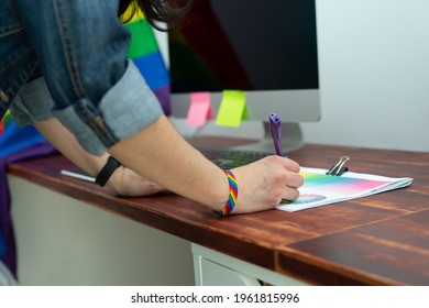 Cultura LGBTQIA. Woman Working In Office With LGBT Accessories.