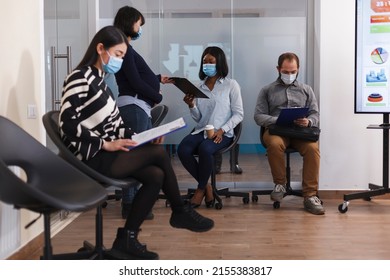 Cultural Diverse Canditates In Waiting Room Carefully Reading Startup Company Internal Regulations And Job Offers Given By Pregnant Manager. Future Mother Giving Woman Recruitment Form While In Lobby