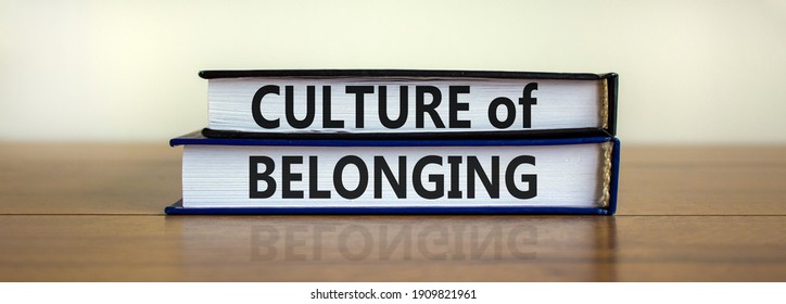 Culture of belonging symbol. Books with words 'culture of belonging' on beautiful wooden table, white background. Business, culture of belonging concept. Copy space.