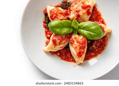 Culurgiones ogliastriniisolated on white background, traditional sardinian pasta stuffed with pecorino, potato and mint and topped with tomato sauce, italian cuisine, european gastronomy  - Powered by Shutterstock