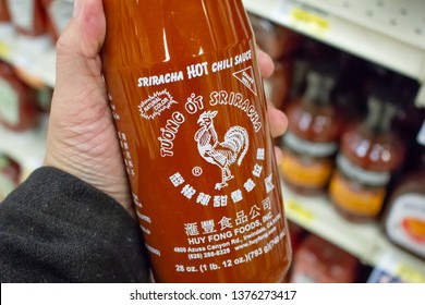 Culver City, California/United States - 4/5/19: A Hand Holds A Big Bottle Of Huy Fong Foods Inc Sriracha Hot Chili Sauce