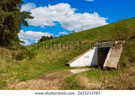 A culvert tunnel going deep under a road

