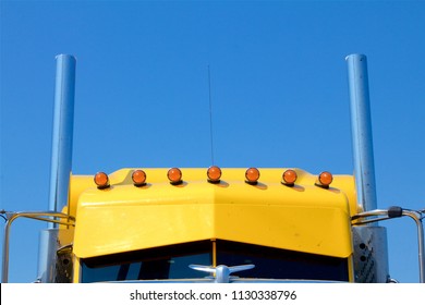 Cumberland County, PA, USA - July 2, 2018: A Bright Yellow Semi-truck Cab With Roof Lights Is Parked At A Popular Truck Stop In Central Pennsylvania.