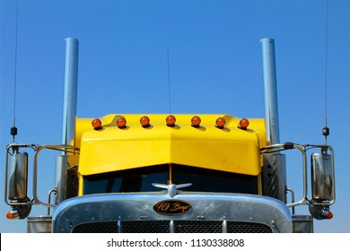 Cumberland County, PA, USA - July 2, 2018: A Bright Yellow Semi-truck Cab With Roof Lights Is Parked At A Popular Truck Stop In Central Pennsylvania.