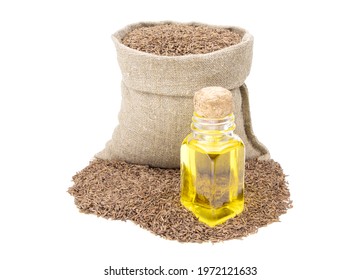 Cumin essential oil. Glass bottle of cummin oil. Caraway in a sack of isolated on a white background. Caraway in a burlap sack. Healthy food.Vegan food. Copy space.Vegan food. Superfood and vitamins.  - Powered by Shutterstock