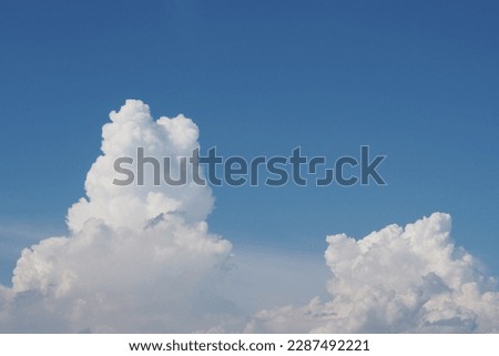 Cumulonimbus clouds against a blue sky background. Cumulus clouds against a blue sky background. Clouds during the day.