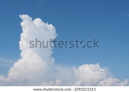Cumulonimbus clouds against a blue sky background. Cumulus clouds against a blue sky background. Clouds during the day.